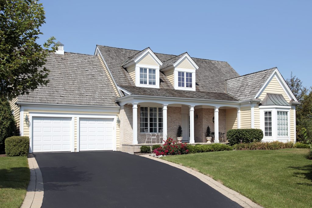 Home with columns and double garage